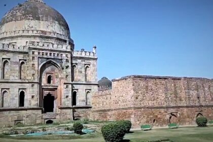 A picture of a fort in Delhi that was built in the 14th century with a garden in front of it