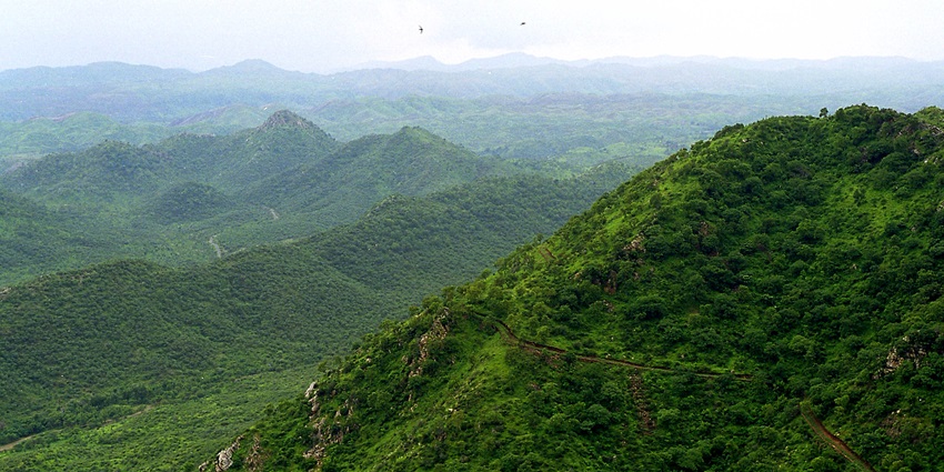 Panoramic view of the Aravalli Range, with rolling hills and lush greenery, including the scenic landscape around Sirohi.