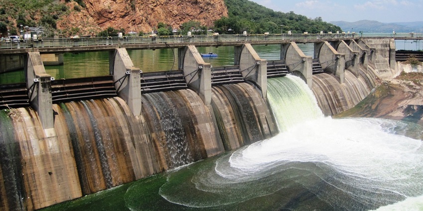 Water flowing through Siswan Dam embraced by rocky hills and sheltered with clear sky, one of the best places to visit in Mohali.