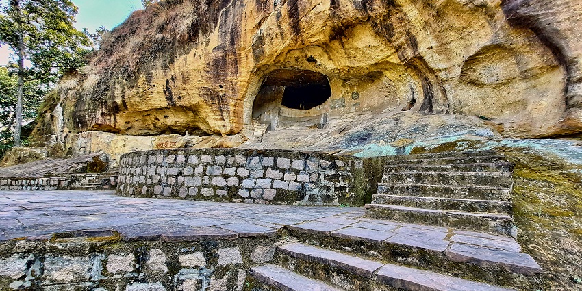 Entrance of Sitabenga Caves with ancient rock formations, surrounded by dense forests