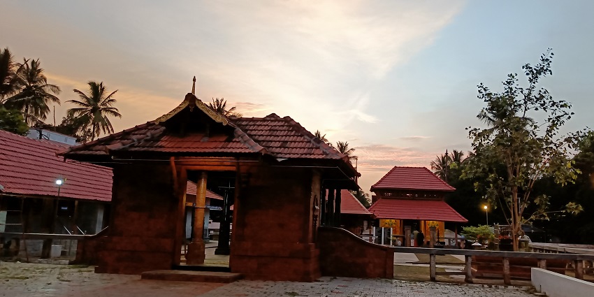 A picture of a historical Shiva temple with a sizable courtyard in front of it