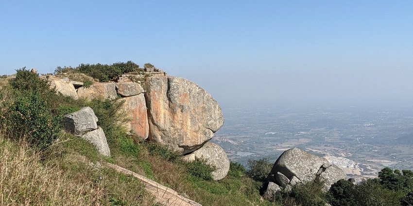 Mist of the early morning covering the rocky Skandagiri Trek path, which leads to an old fort.