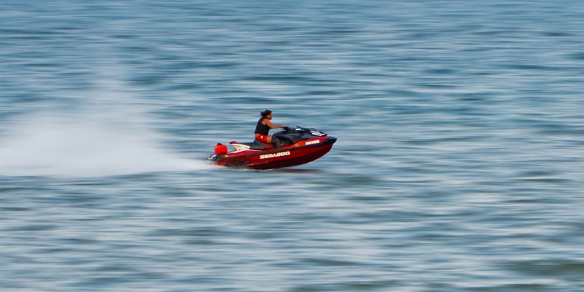 A breathtaking view of a person enjoying jet skiing on a body of water during the day.
