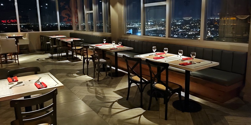 A picture of a rooftop bar at the State Tower in Bangkok, taken at night time