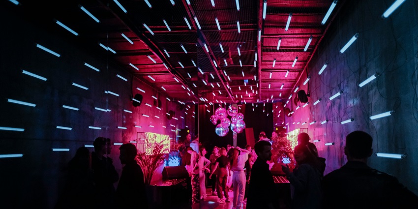Crowds dancing under lights at Soi Bangla, a place to enjoy Phuket nightlife for singles.