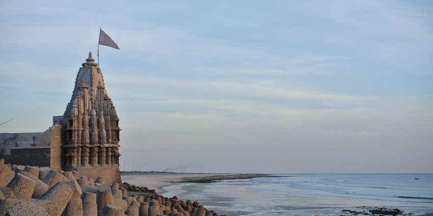 Visitors enjoying the scenic view of the sea at Somnath Beach.