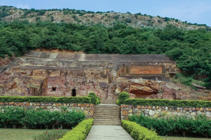 A panoramic view of Sonbhandar Caves in Rajgir, Bihar surrounded by greenery