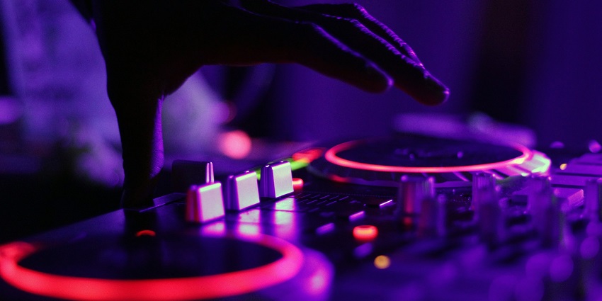 An image of a DJ with neon lights, reflecting the energetic vibe of nightlife in the country.