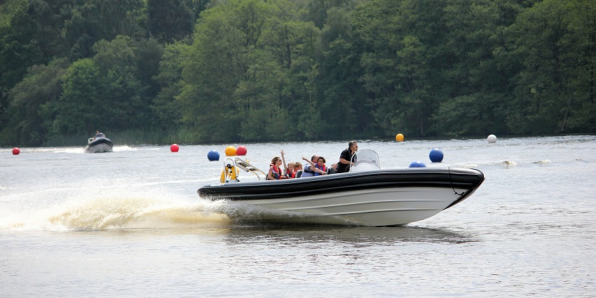 A picture of an adventurous speed boat ride at Palolem Beach with blue waters in the background