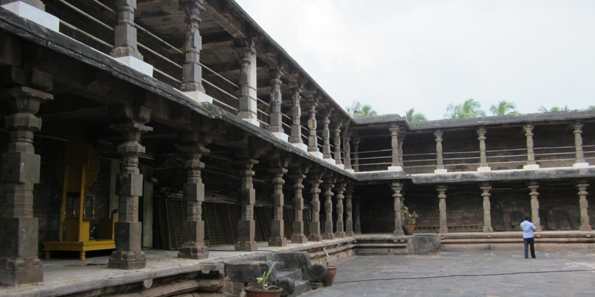 A picture of the internal compound of a historical Shiva temple with intricate carvings