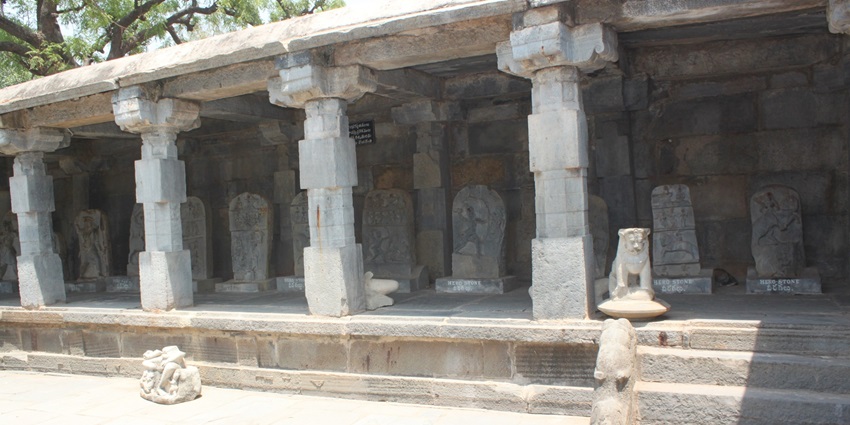 A picture of a historical temple premises with stone pillars and intricate architecture