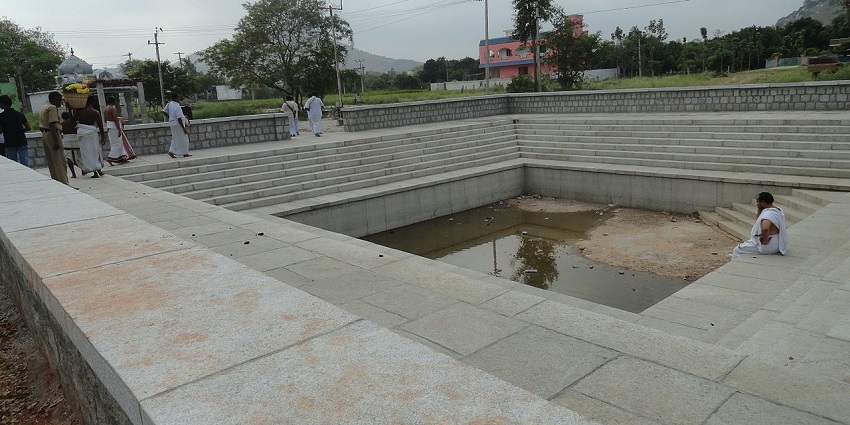 Priests gathering around the temple tank at Sri Prasanna Venkateswara Swamy Temple