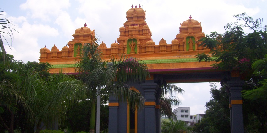 A breathtaking view of an entrance leading to the Sri Trimurtidham Balaji Temple.