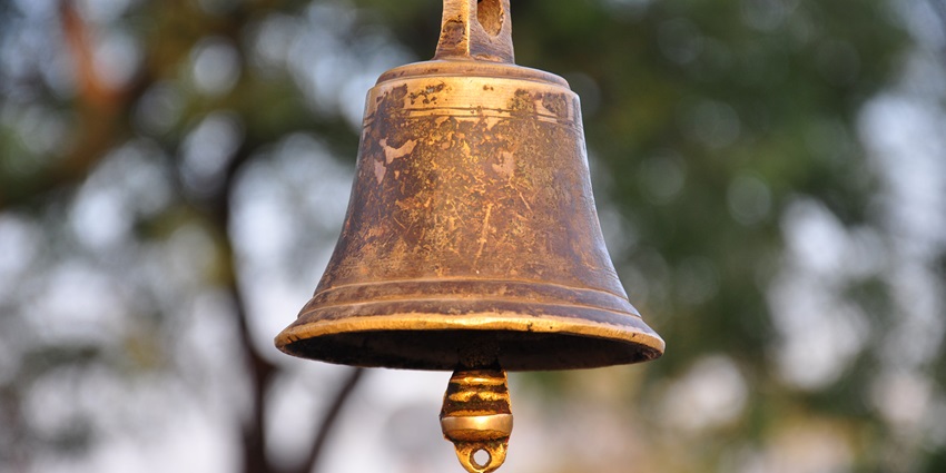 Image of a temple bell with blurred background displayed in a temple