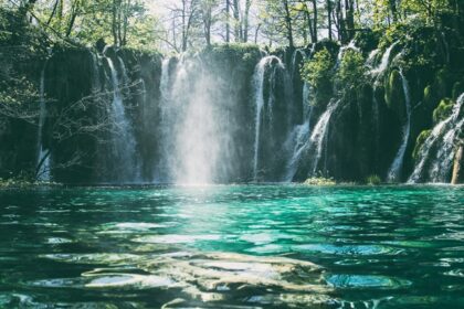 A breathtaking view of a waterfall surrounded by lush greenery during the daytime.