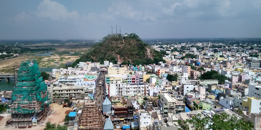 An aerial picture of a city with a hill in the middle of residential apartments in Andhra Pradesh