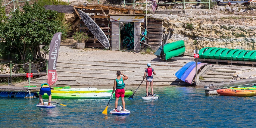 Stand-up paddleboarding is an exciting option among Baga Beach water sports.