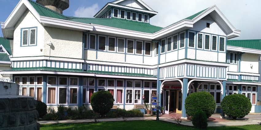 Entrance to a museum, similar to museums in Ranchi with lush greenery.