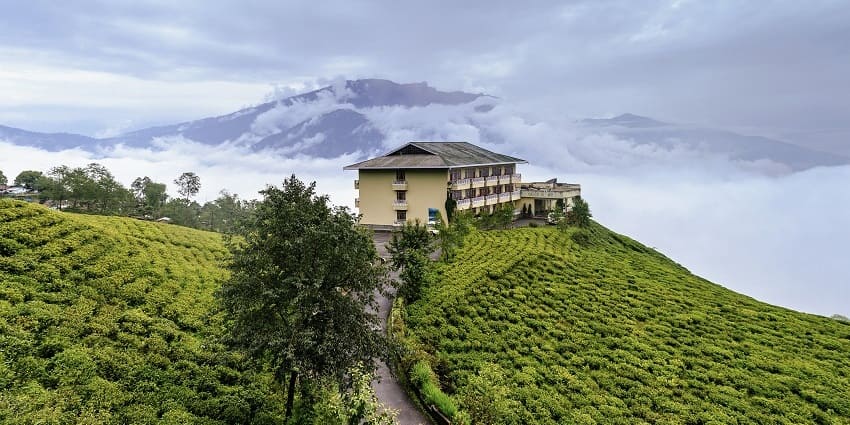 A serene mountain resort, surrounded by snow-covered peaks in the Himalayas.