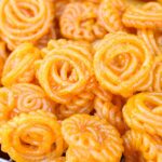 A mouthwatering view of a person selling orange jalebis in Rajasthan to everyone.