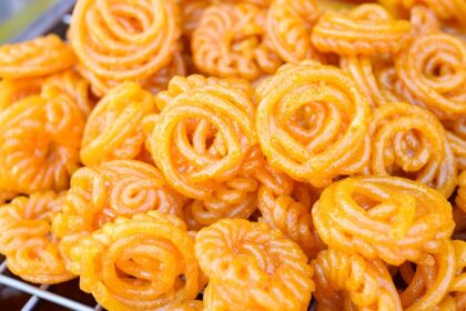 A mouthwatering view of a person selling orange jalebis in Rajasthan to everyone.