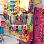 Vibrant street shopping in Ahmedabad selling traditional clothes and handicrafts.