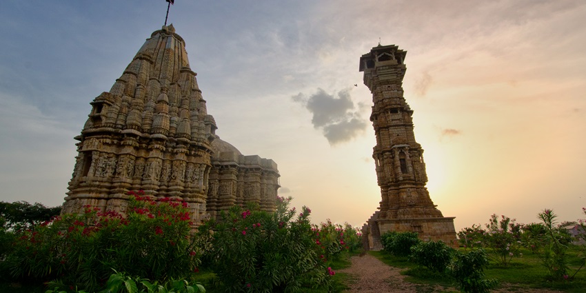 Kirti Stambh with adjacent temple in Chittorgarh Fort, highlighting Rajput architectural heritage.