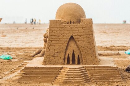 Exterior view of the Sudam Sand Art Museum in Odisha covered with a big sand sculpture