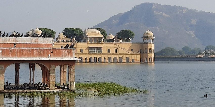 Image of a grand Rajasthani fort with traditional architecture, featuring large domes