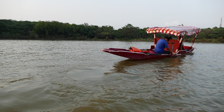 Scenic view of the man made Sukhana lake, with a small boat sailing in it