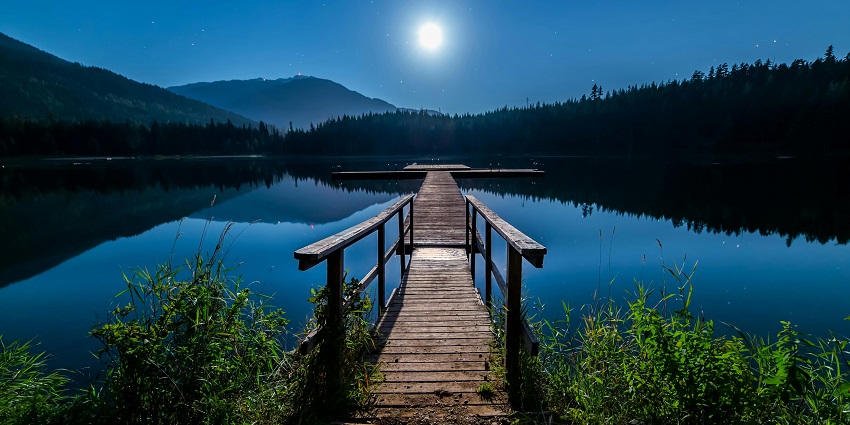 A night view of the famous Sukhna Lake casting beautiful reflection of the shining moon.