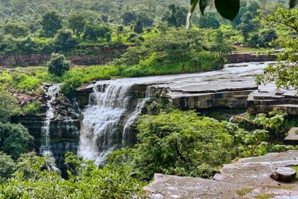 The landscape picture of the Sultan Garh Waterfalls with high mountains surrounding