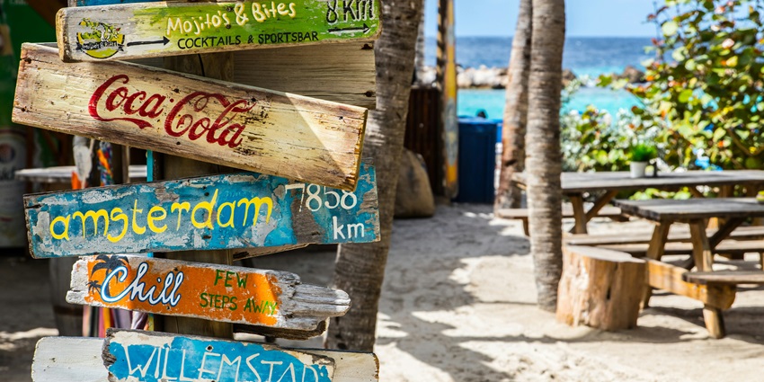 A glimpse of the Sunflower Beach Bar featuring colourful sign boards and scenic views.