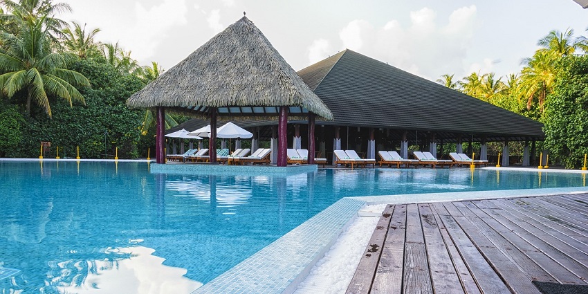 A tranquil poolside at Sunrise Naturopathy Health Resort, Jaipur, offering relaxation and wellness.