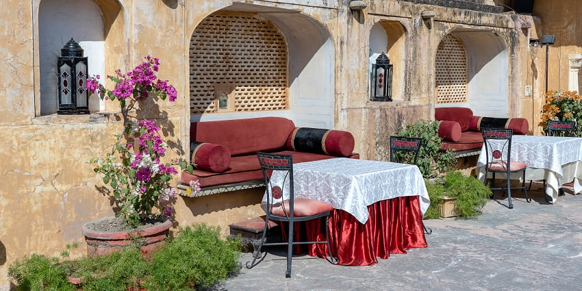 An image of the beautiful sitting settings of a fort side cafe under a bright blue sky.