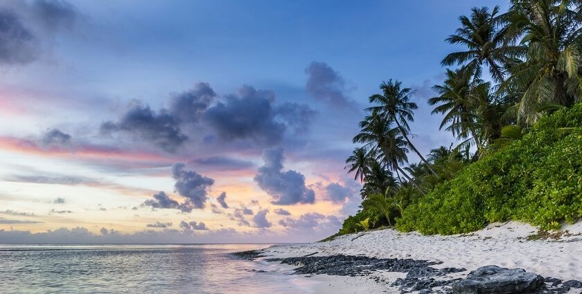 A serene sunset over a tranquil beach, with vibrant colours - things to do in ongole.