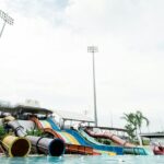 Children gleefully splash down colourful water slides, enjoying endless fun in the bright pool