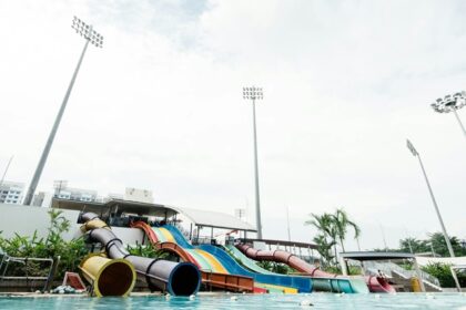 Children gleefully splash down colourful water slides, enjoying endless fun in the bright pool