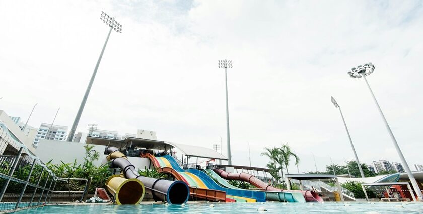 Children gleefully splash down colourful water slides, enjoying endless fun in the bright pool