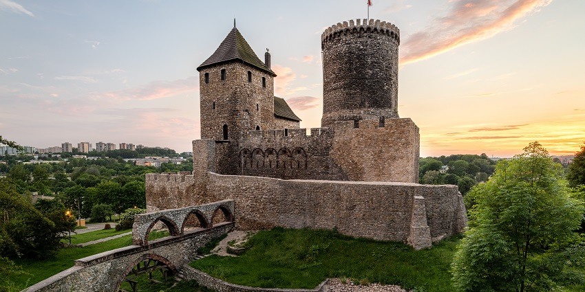 The view of the castle surrounded by lush leafage.