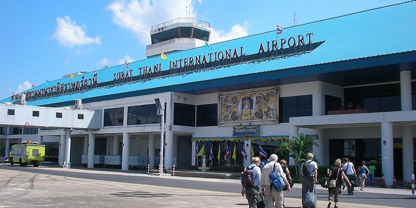 Main entrance to one of the airports in Thailand, with passengers entering the airport.