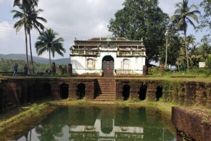 Picturesque view of the Surla mosque, with a small pond at the front surrounded by lush trees