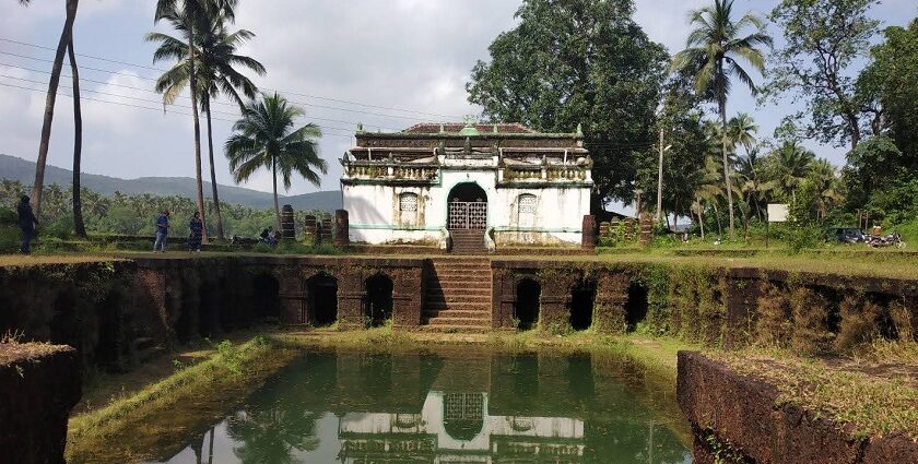 Picturesque view of the Surla mosque, with a small pond at the front surrounded by lush trees