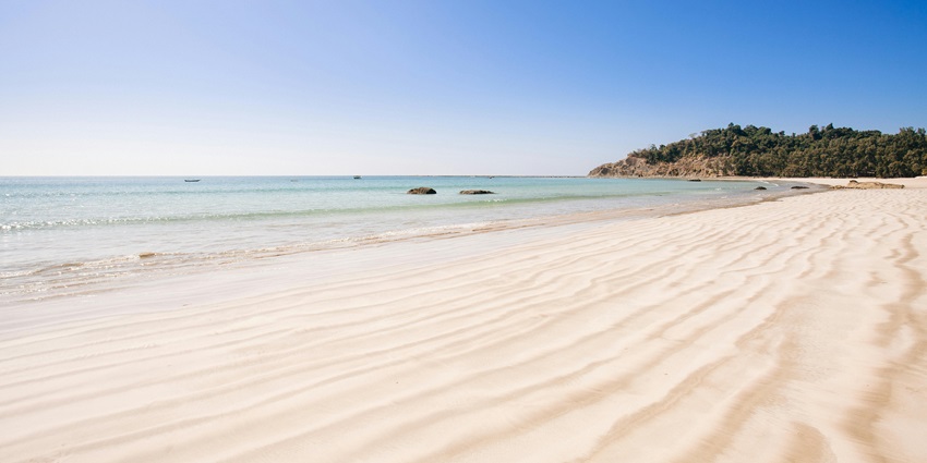 A breathtaking vista of Suruchi Beach featuring turquoise-blue waters and golden sands.