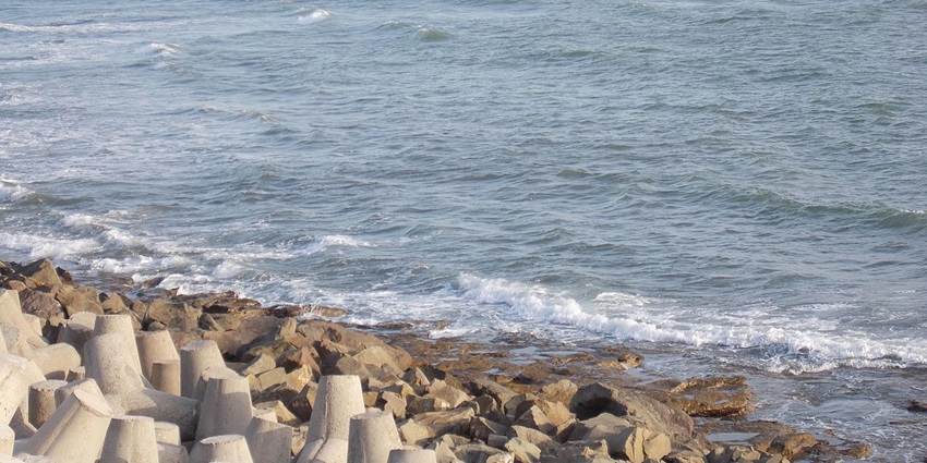 Scenic view of the Suvali beach, showcasing the waves crashing the rocky shores.