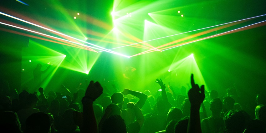 People under neon lights at Suzy Wong, a place to enjoy Phuket nightlife for singles.
