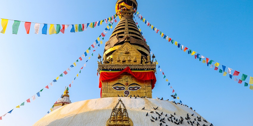 Ancient Swayambhunath temple in Nepal, showcasing intricate architecture and vibrant colours.
