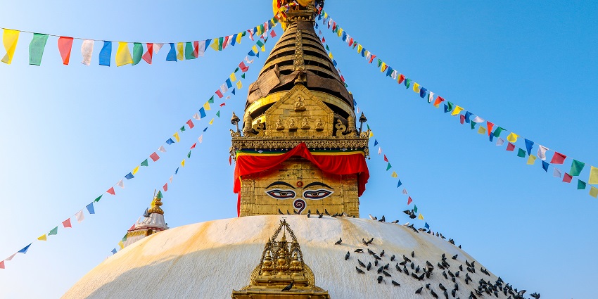 An important site to visit near Pashupatinath Temple with a golden spire and prayer flags.