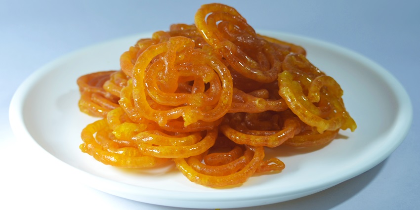 Traditional sweets like jalebis and gulab jamuns are served at Sweet Treats