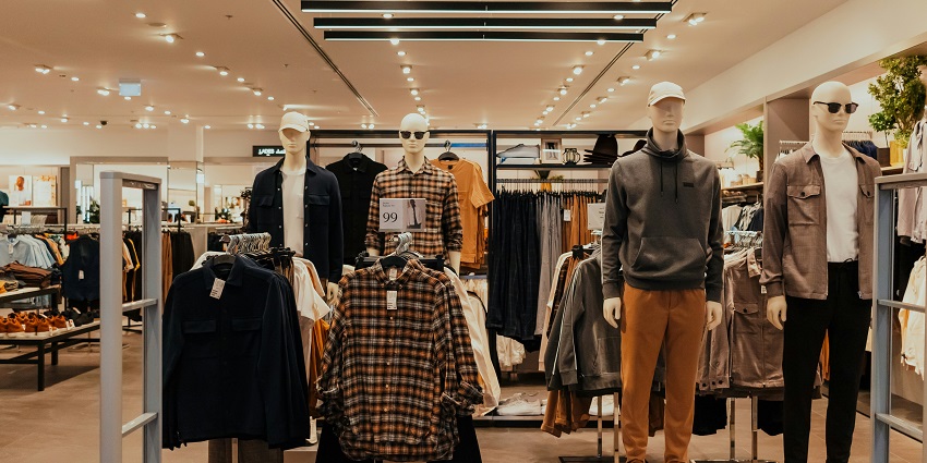 A retail clothing store with a lot of clothes and manikins at the famous TDI Mall.